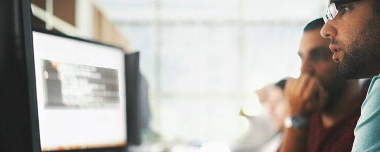 Men looking at computer screen