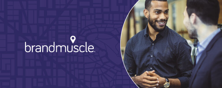 BrandMuscle logo with photo of two business professional men talking